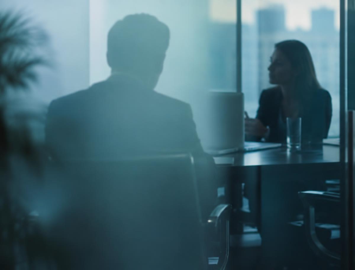 Leaders meeting behind frosted glass